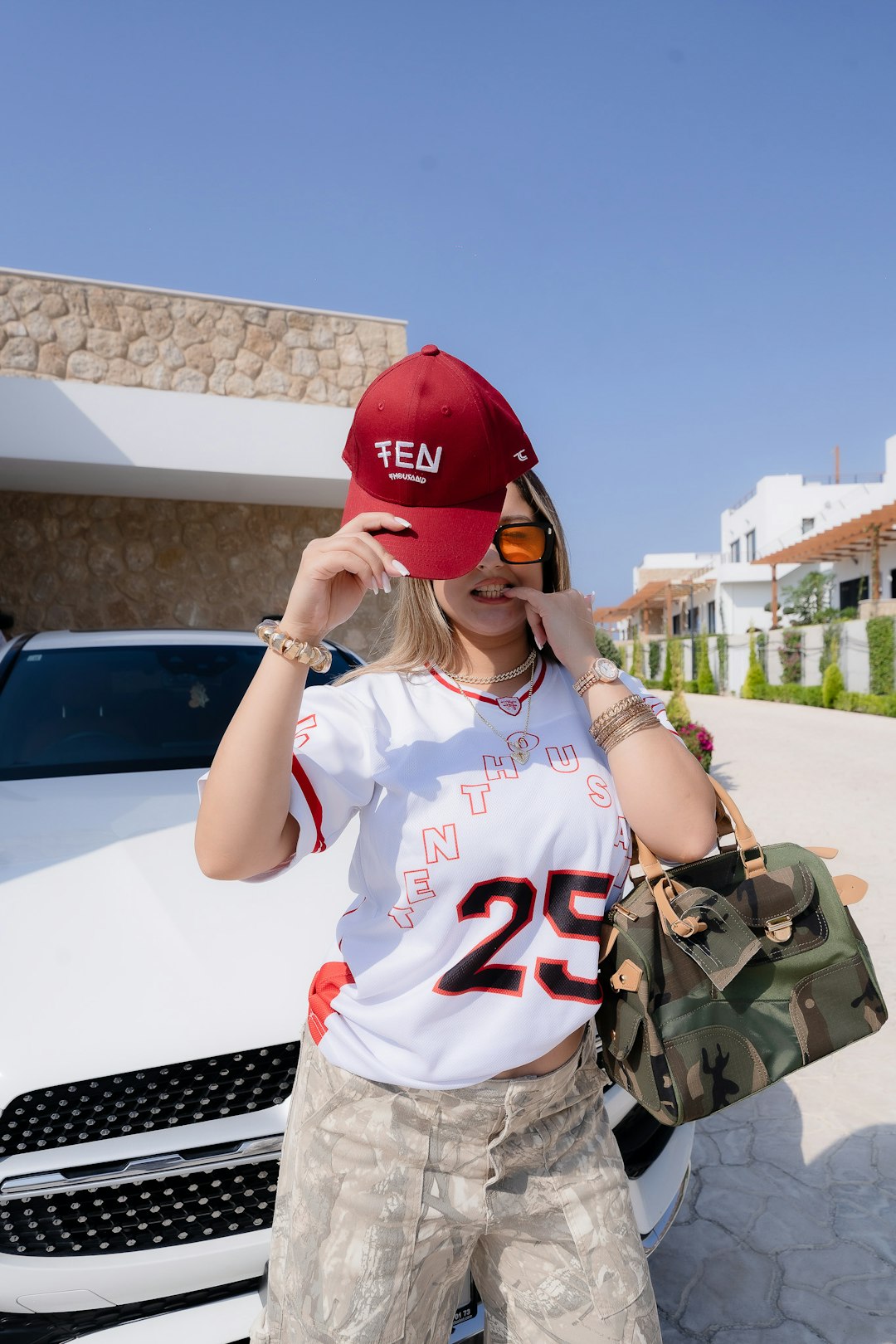 Streetwear energy with bold jerseys, creative styling, and a bright outdoor backdrop.